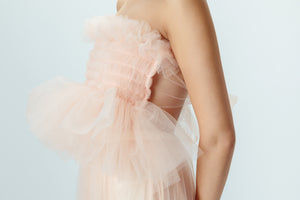 Model wearing blush pink tulle top with tie back