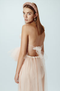Model wearing blush pink tulle top back view